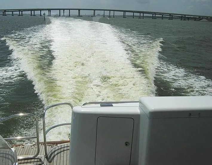 Slide: The Image of Custom Axcell Yachts 650 Power Catamaran cruising, leaving a wake, bridge in background, 2010 model. - 12