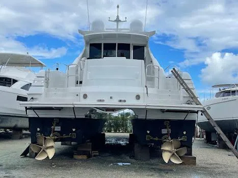 Slide: The Image of Custom Axcell Yachts 650 Power Catamaran 2010, docked with visible propellers and blue sky background. - 20