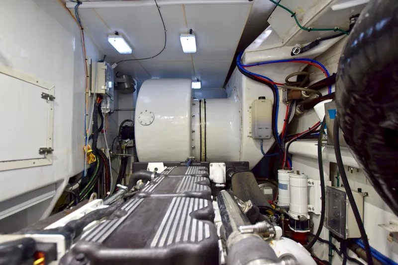 Slide: The Image of Engine room of 2010 Custom Axcell Yachts 650 Power Catamaran, showcasing machinery and wiring. - 30