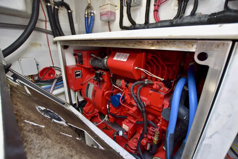 Slide: The Image of Engine room of 2010 Custom Axcell Yachts 650 Power Catamaran, featuring red machinery and wiring. - 32
