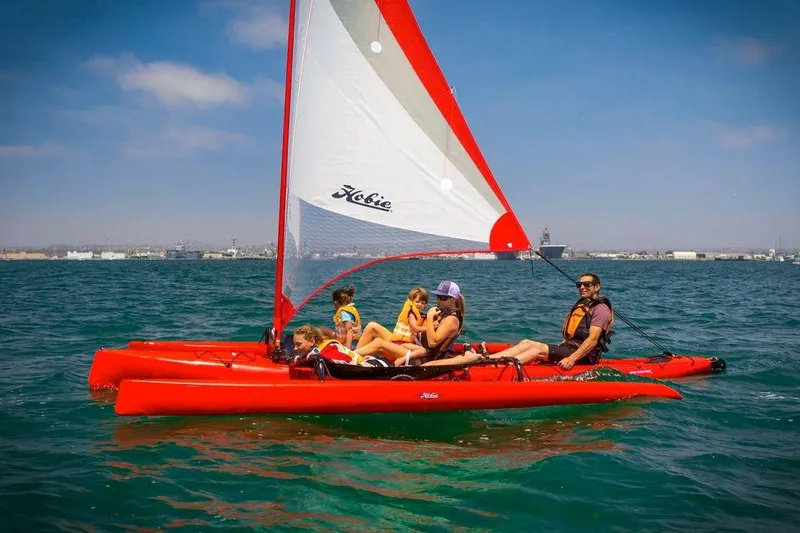 Slide: The Image of 2023 Hobie Mirage Tandem Island sailing kayak with family on the water. - 4