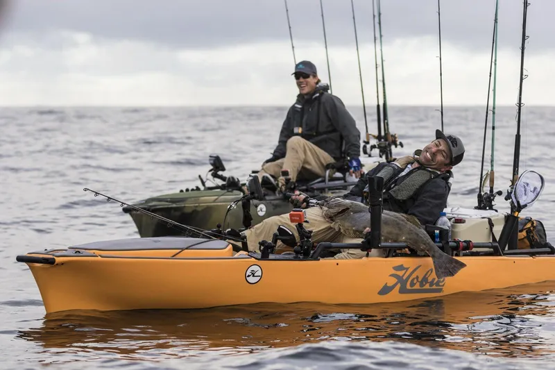 The Image of Two anglers fishing from Hobie Mirage Pro Angler 14 kayaks on open water. - 0
