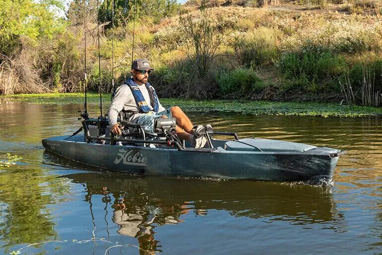 The Image of Man fishing on a 2023 Hobie Pro Angler 12 kayak in a serene river. - 0