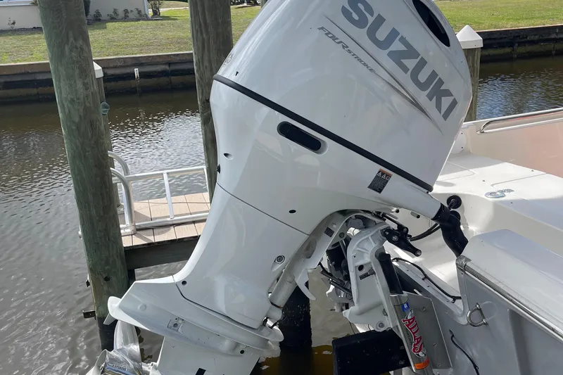 Slide: The Image of Suzuki outboard motor on a 2021 Bulls Bay 2000 boat docked by the water. - 4