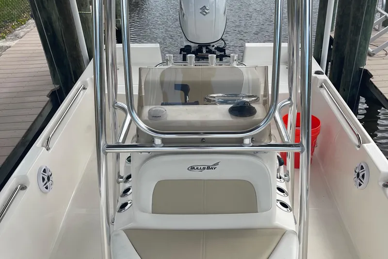 Slide: The Image of 2021 Bulls Bay 2000 boat interior with center console and Suzuki outboard motor. - 7