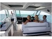 Slide: The Image of 2024 Formula 380 Super Sport Crossover interior with passengers enjoying a scenic ocean view. - 17