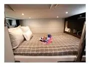 Slide: The Image of 2024 Formula 380 Super Sport Crossover cabin with cozy bed and ambient lighting. - 20