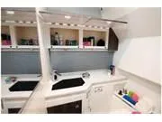 Slide: The Image of 2024 Formula 380 Super Sport Crossover interior kitchen area with modern amenities. - 21