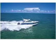 Slide: The Image of 2024 Formula 380 Super Sport Crossover cruising on open ocean under clear blue sky. - 3