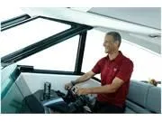 Slide: The Image of Man piloting 2024 Formula 500 Super Sport Crossover boat, smiling at helm. - 15
