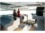 Slide: The Image of 2024 Formula 500 Super Sport Crossover interior with two people enjoying the spacious cabin. - 25