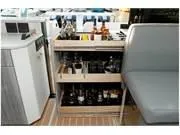 Slide: The Image of 2024 Formula 500 Super Sport Crossover interior with a stocked bar and seating area. - 26