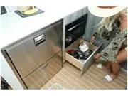 Slide: The Image of 2024 Formula 500 Super Sport Crossover interior kitchen with stainless steel appliances and storage. - 32