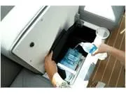 Slide: The Image of 2024 Formula 500 Super Sport Crossover storage compartment with a person placing a water bottle inside. - 39