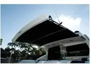 Slide: The Image of 2024 Formula 500 Super Sport Crossover yacht with extended sunshade, palm trees in background. - 45