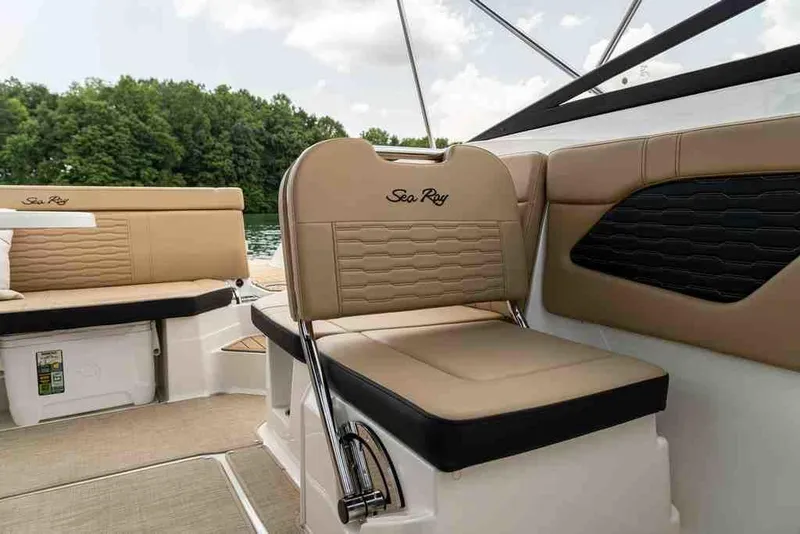 Slide: The Image of 2024 Sea Ray SPX 230 boat interior with tan seating and lake view. - 4