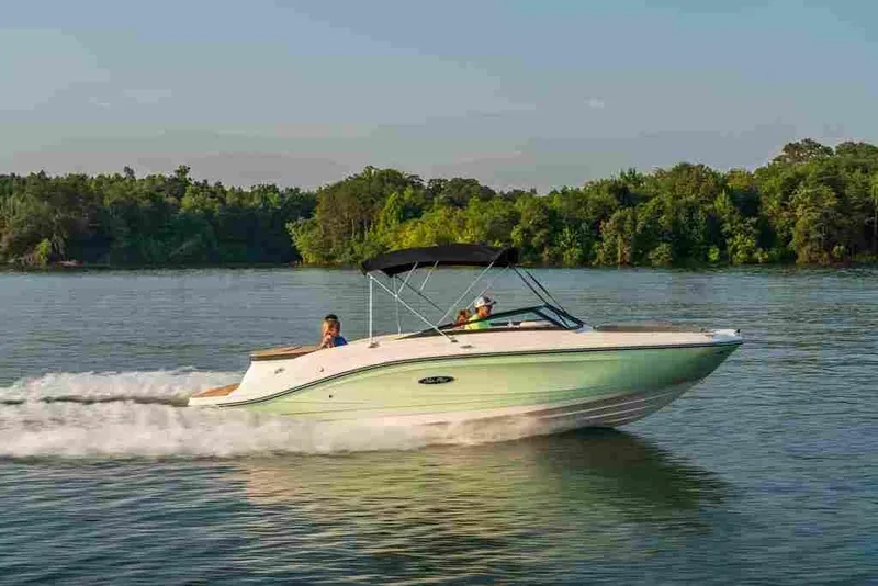 Slide: The Image of 2024 Sea Ray SPX 230 boat cruising on a lake. - 6