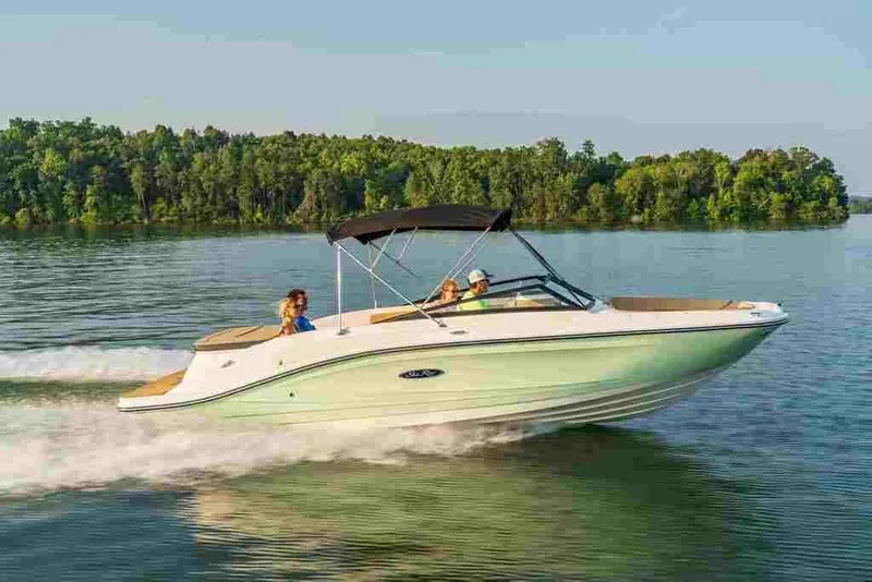 Slide: The Image of 2024 Sea Ray SPX 230 boat cruising on a lake with lush green trees in the background. - 7