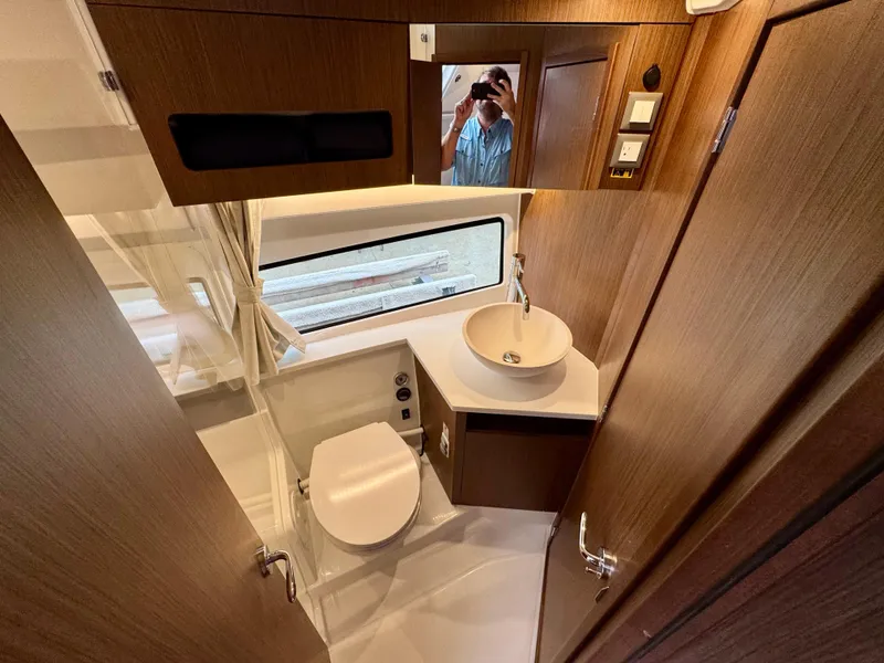 Slide: The Image of 2025 Beneteau Antares 11 bathroom with modern fixtures and wood accents. - 28