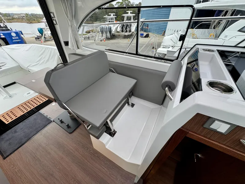 Slide: The Image of 2025 Beneteau Antares 11 interior with modern seating and helm station. - 30
