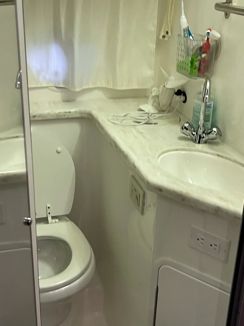 Slide: The Image of Bathroom interior of 2014 Rinker 360 Express Cruiser with sink and toilet. - 10
