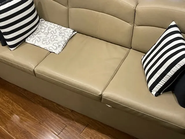 Slide: The Image of Beige leather sofa with striped pillows on a Rinker 360 Express Cruiser, 2014 model. - 16