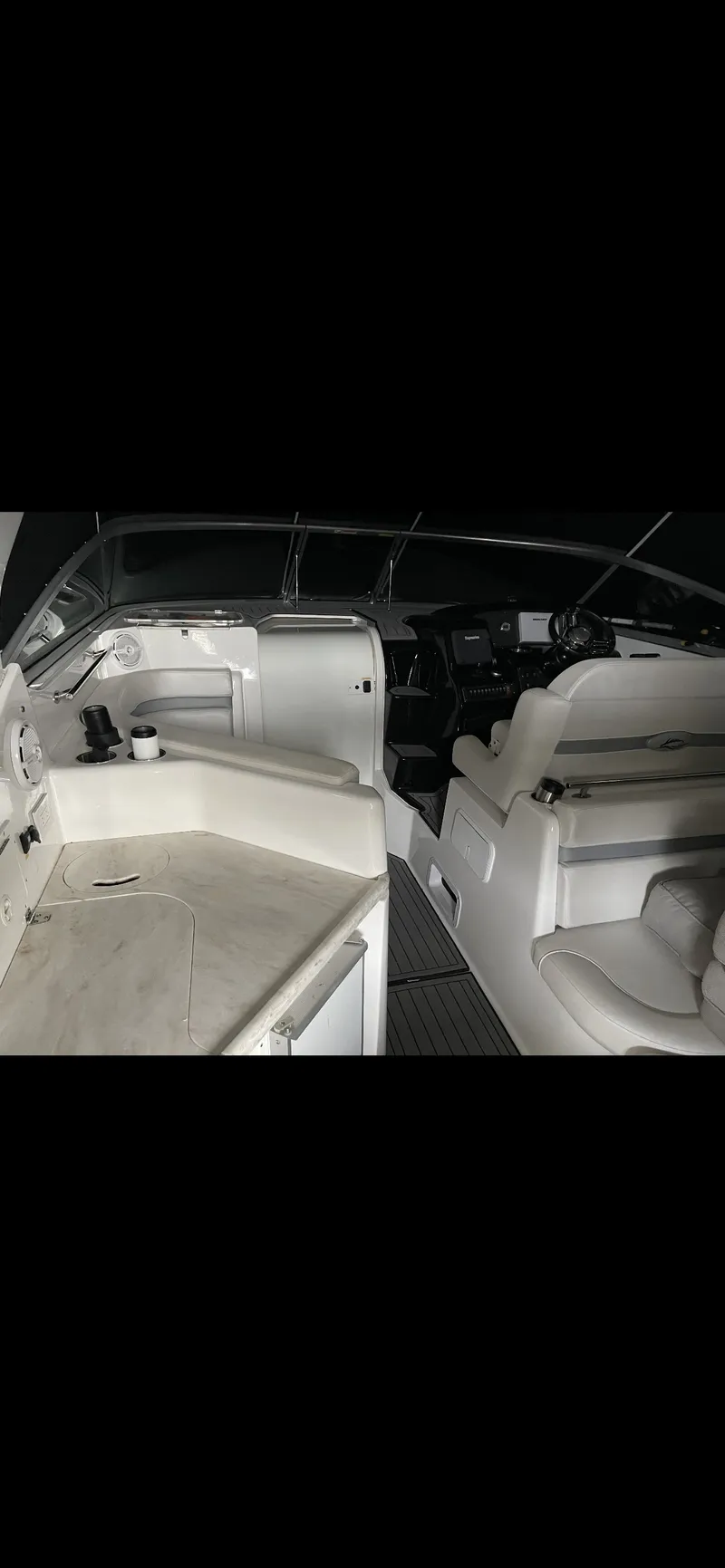 Slide: The Image of 2014 Rinker 360 Express Cruiser interior with seating and helm. - 4
