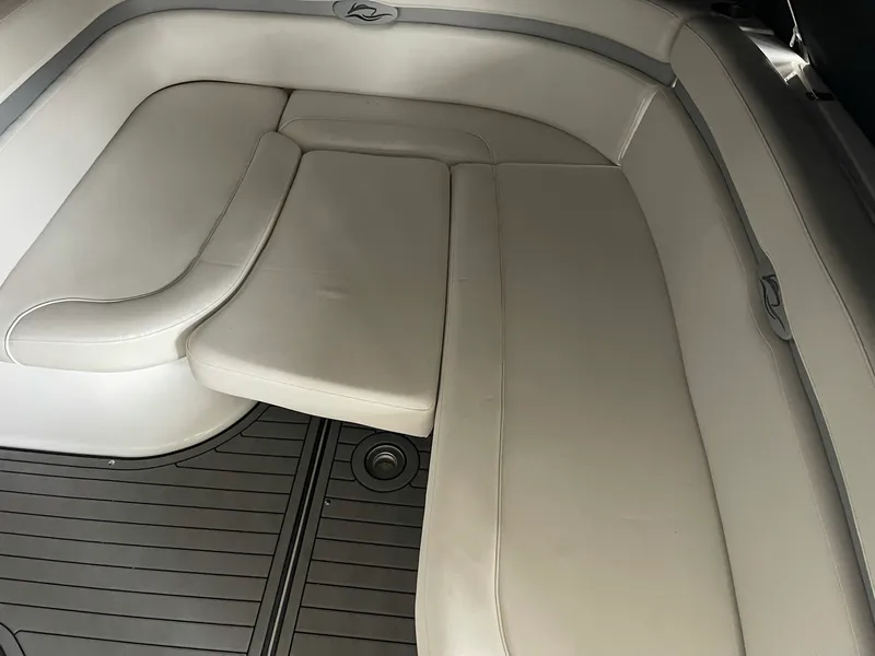 Slide: The Image of 2014 Rinker 360 Express Cruiser interior seating with beige upholstery and sleek design. - 7