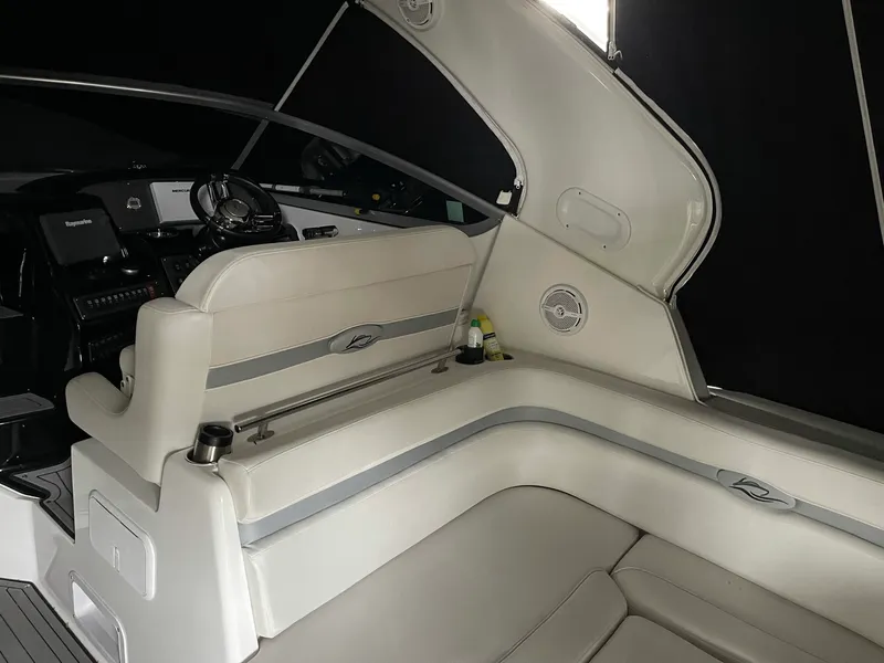 Slide: The Image of 2014 Rinker 360 Express Cruiser interior with white seating and modern dashboard. - 8