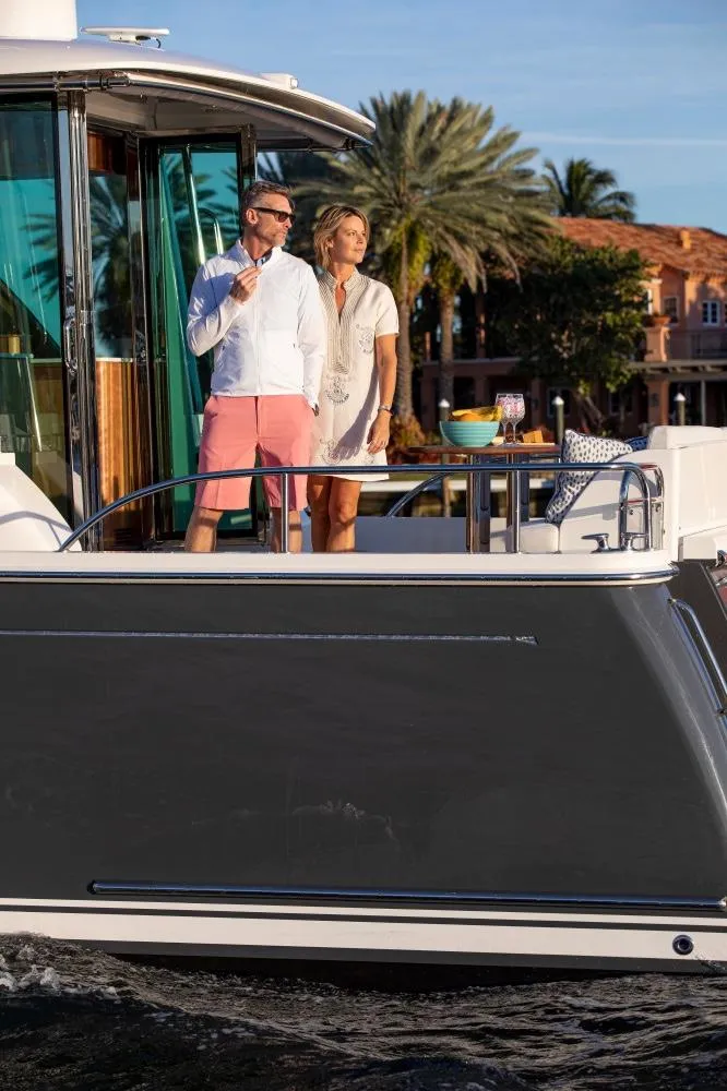 Slide: The Image of Couple enjoying the deck of a 2025 Sabre 58 Salon Express yacht. - 21