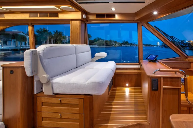 Slide: The Image of Interior of 2025 Sabre 58 Salon Express yacht with plush seating and wooden finishes. - 7