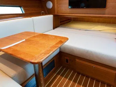 Slide: The Image of Interior of 2025 Sabre 43 Salon Express yacht with wooden table and white seating. - 10