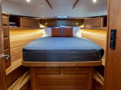 Slide: The Image of Luxurious bedroom in 2025 Sabre 43 Salon Express yacht with wooden interior. - 11