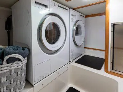 Slide: The Image of Laundry area in 2025 Sabre 43 Salon Express yacht with washer and dryer. - 13
