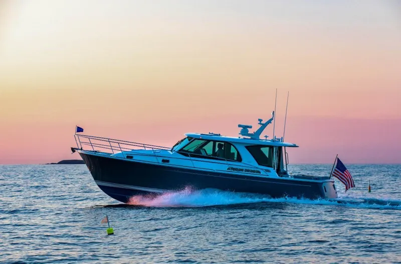 Slide: The Image of 2025 Sabre 43 Salon Express yacht cruising at sunset. - 2