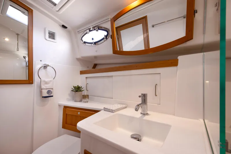 Slide: The Image of Luxurious bathroom interior of 2027 Back Cove 412 yacht with modern fixtures and wooden accents. - 10