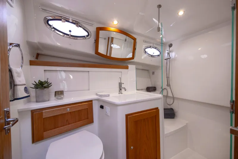 Slide: The Image of Luxurious bathroom in 2027 Back Cove 412 yacht with modern fixtures and wood accents. - 11