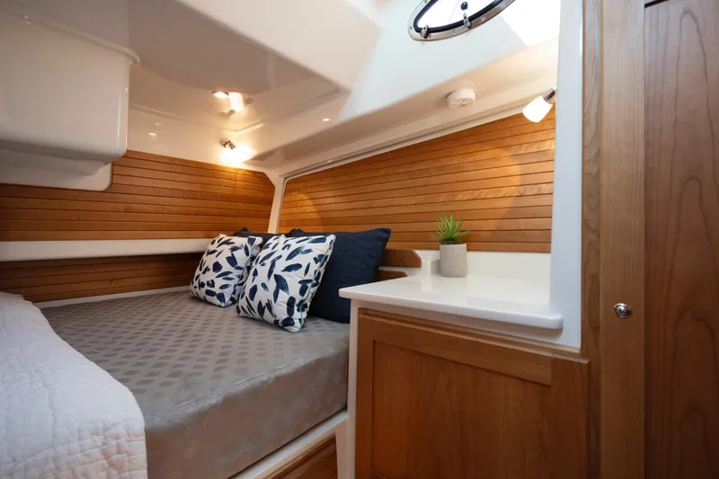 Slide: The Image of Luxurious cabin interior of 2027 Back Cove 412 yacht with cozy bedding and wooden accents. - 12