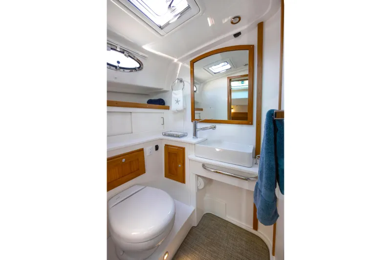 Slide: The Image of Luxurious bathroom in 2027 Back Cove 412 yacht, featuring modern fixtures and elegant wood accents. - 13