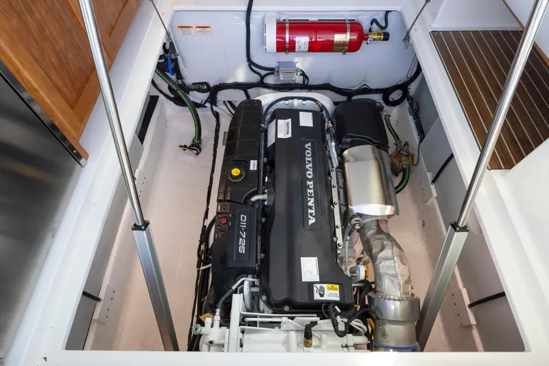 Slide: The Image of Engine compartment of 2027 Back Cove 412 with Volvo Penta engine and fire extinguisher. - 15