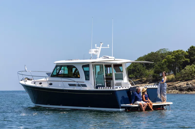 Slide: The Image of 2027 Back Cove 412 yacht on water with people enjoying the sun. - 2