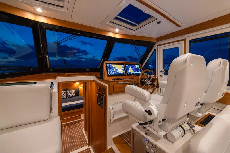 Slide: The Image of Luxurious interior of 2027 Back Cove 412 yacht with modern navigation system and plush seating. - 5