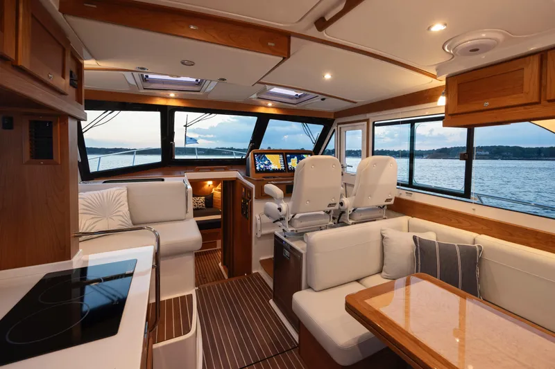 Slide: The Image of Luxurious interior of 2027 Back Cove 412 yacht with modern seating and navigation equipment. - 6