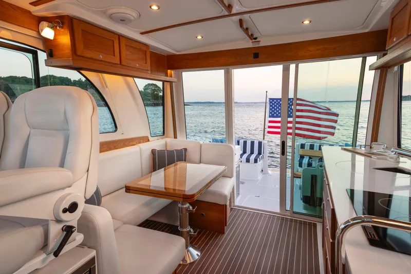 Slide: The Image of Luxurious interior of 2027 Back Cove 412 yacht with American flag and ocean view. - 7