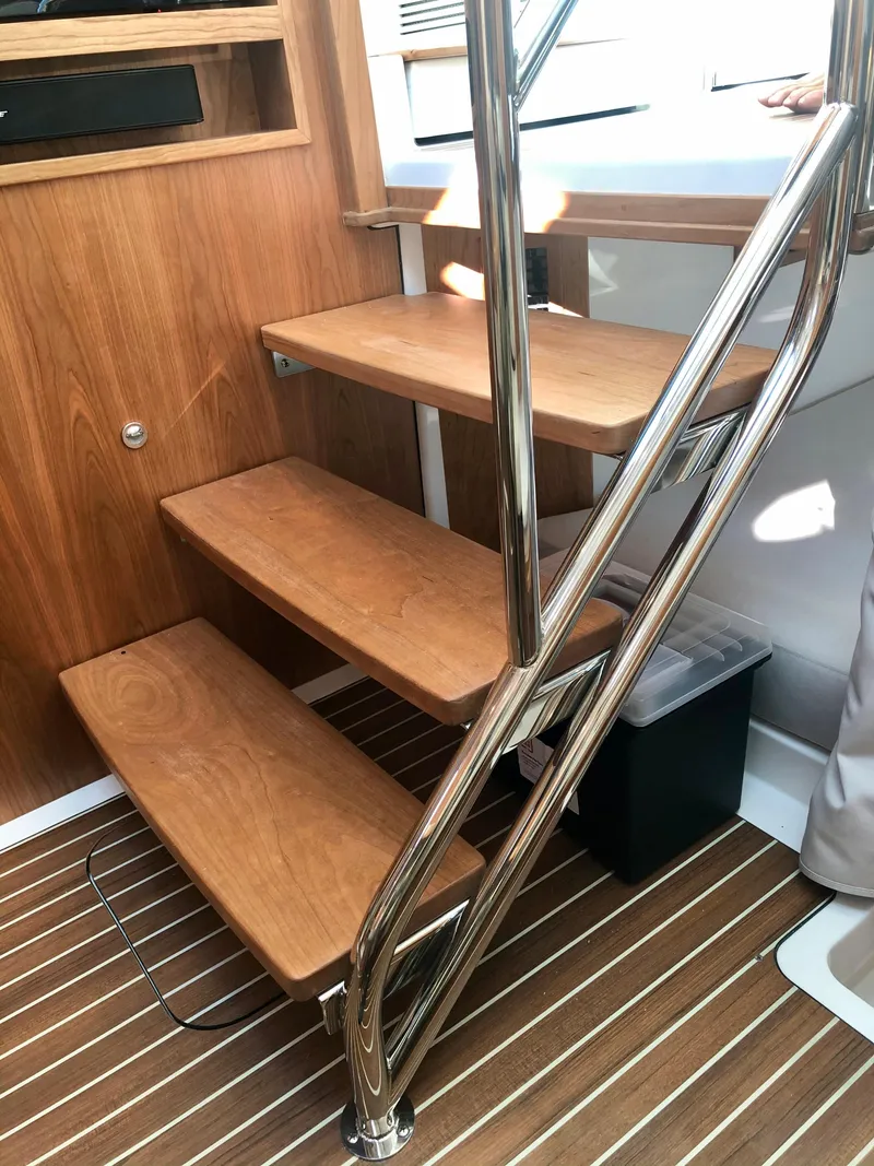 Slide: The Image of Back Cove 390 2025 interior wooden stairs with stainless steel railing - 19