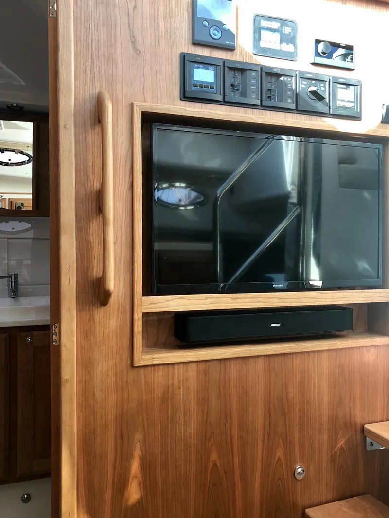 Slide: The Image of 2025 Back Cove 390 yacht interior with TV and control panel - 24