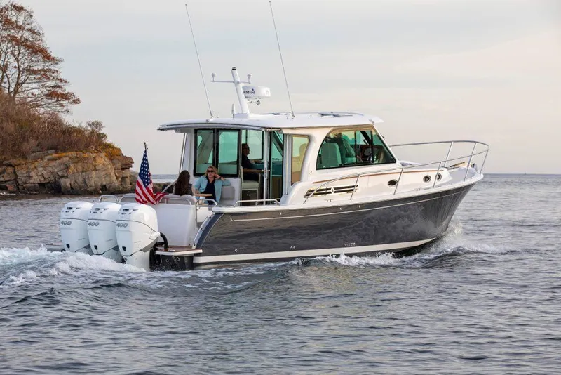 Slide: The Image of 2025 Back Cove 390 boat cruising on water with passengers. - 40