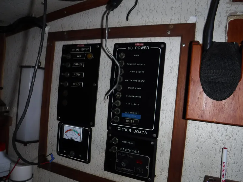 Slide: The Image of Control panel of a 1978 Fortier 26 boat with switches and gauges. - 12