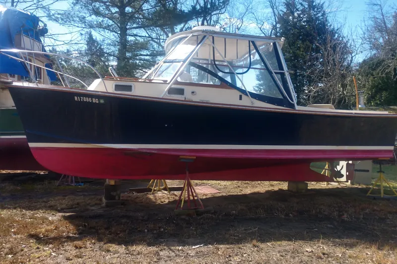 Slide: The Image of 1978 Fortier 26 boat on stands outdoors. - 16