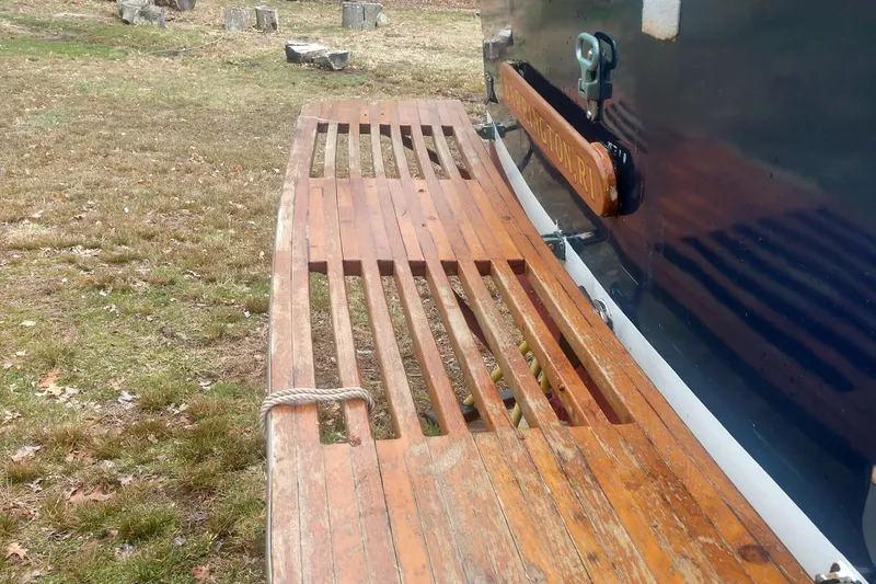 Slide: The Image of Wooden platform of a 1978 Fortier 26 boat on grass. - 17